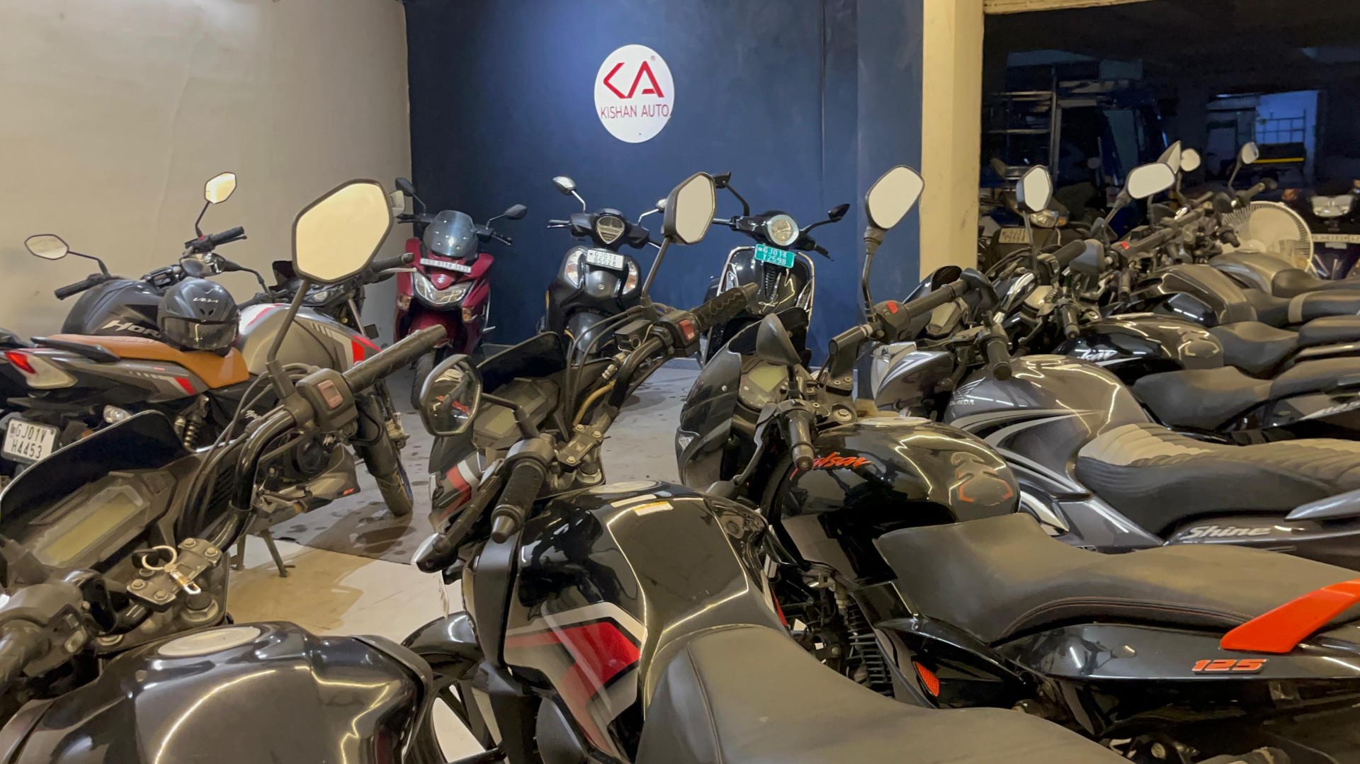 Row of used motorcycles ready for delivery at Kishan Auto Consult, Dariyapur Ahmedabad