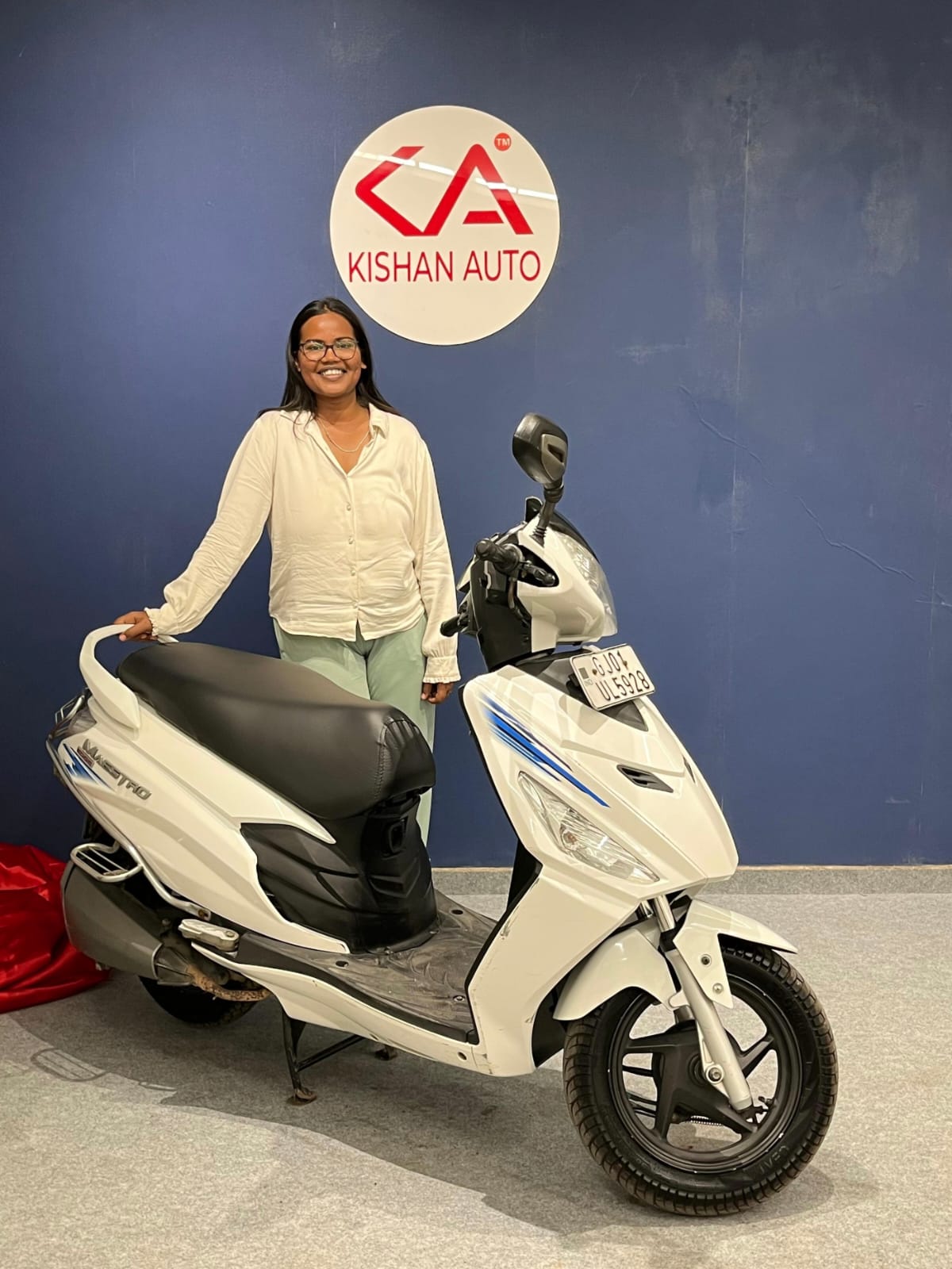 Female customer with new used scooter purchased from Kishan Auto Consult, Ahmedabad